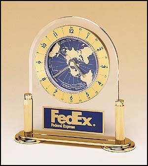 Arched acrylic clock with World Time dial and three hand movement on a gold-plated solid brass base with columns